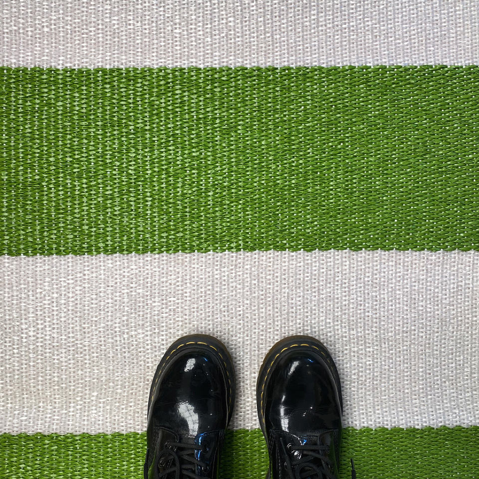 Closeup green and white plastic rug